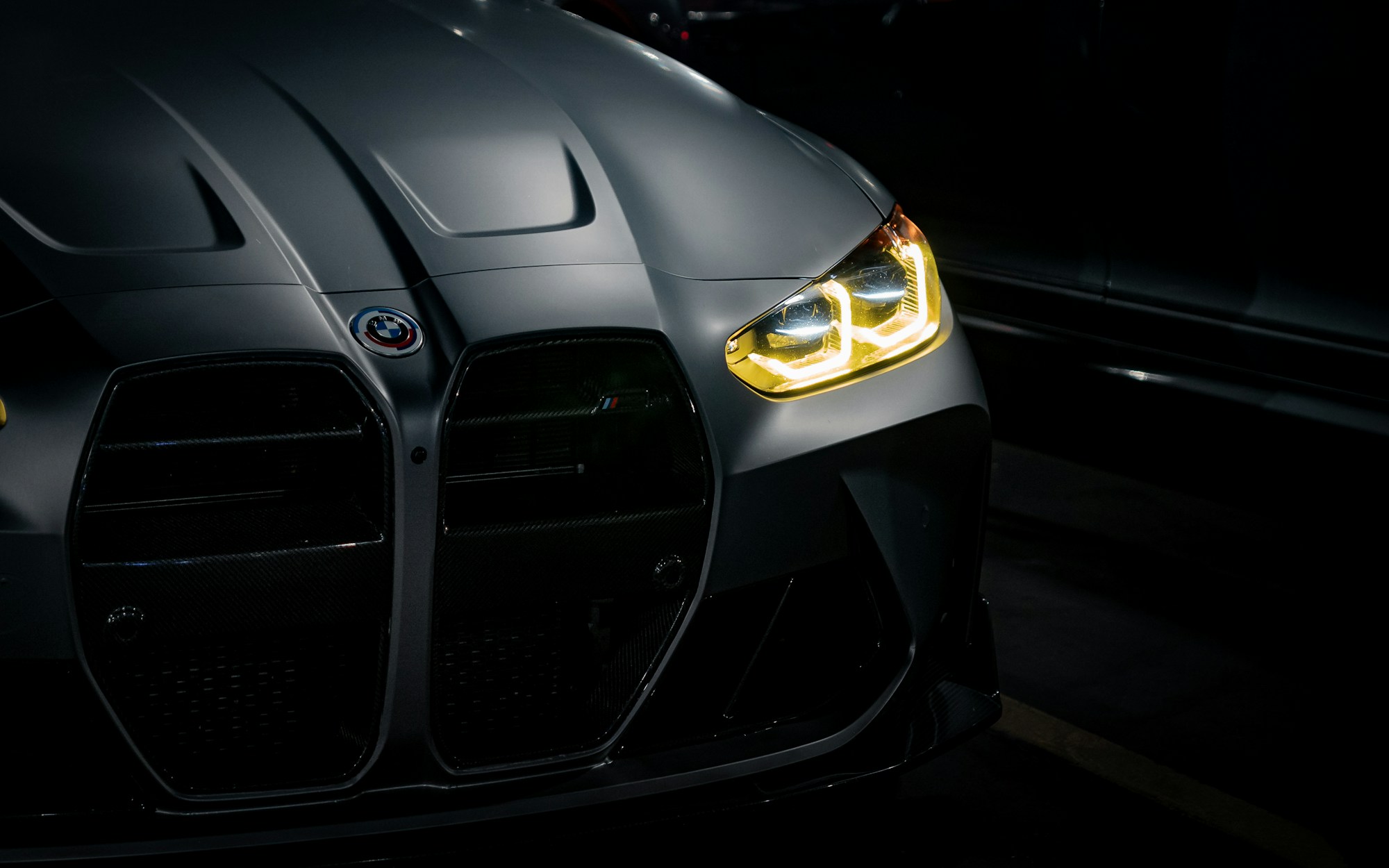 Graphite sports car in a dark studio